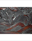 Dark rosewood wall plaque with hand-carved floral, leafy, and abstract natural patterns.