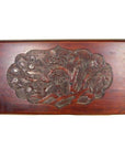 Reddish-brown lacquered rosewood wall plaque with hand-carved 19th-century floral and leaf details, close-up view.