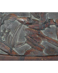 Close-up of intricate floral and leaf motifs carved into an antique rosewood wall plaque with a weathered lacquered finish.