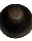 Brown wooden hand-carved antique offering bowl with rounded shape and simple design, close-up on plain background.