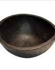 Dark wood hand-carved antique offering bowl, large and round, on white background.
