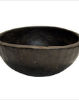 Round rustic wooden bowl, hand carved antique, displayed against a plain white background.