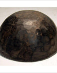Dark wood hand carved antique offering bowl with worn finish on light surface.