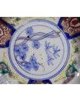Close-up of blue and multicolored hand painted Japanese Imari porcelain bowls, set of 4, floral border designs.