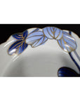 Close-up of four blue and gold hand painted Japanese Imari porcelain bowls with leaf designs.