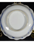 Blue and white porcelain bowls, hand-painted, set of 4 on gold stand, black background.