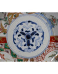 Close-up of blue and red hand painted Japanese Imari porcelain bowl with gold and green floral patterns.