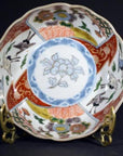 Blue and white porcelain Imari bowls with hand-painted floral and crane designs, set of 4 on ornate gold stands.