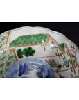 Close-up of a green, blue, and gold porcelain bowl with painted patterns, antique Japanese Imari style.