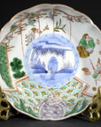 Multicolor porcelain Imari bowl with hand painted scenes and geometric patterns on brass stand, close-up.