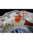 Set of 4 red and white porcelain Imari bowls with hand-painted figures in robes and floral designs, grouped together.