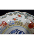 Blue, red, and white porcelain Imari bowls set of 4 with hand-painted figures and floral patterns, scalloped edges.