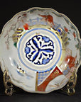 Colorful porcelain Imari bowls set of 4, hand-painted, displayed on stands against a black background.