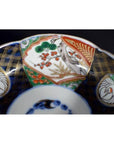 Close-up of an antique hand painted Japanese Imari porcelain bowl with bird and floral patterns.