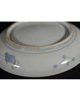 White porcelain bowl with blue edge designs, hand painted, shown upside down.