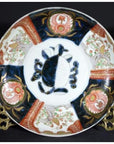 Multicolored porcelain Imari bowl with hand painted turtle and floral motifs, close-up of antique Japanese design.