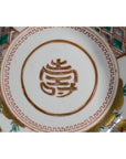 Close-up of antique hand painted Japanese Imari porcelain bowl base with red character and colorful patterns.