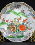 Multicolor porcelain Japanese Imari bowl with hand painted florals and birds on ornate brass stand.