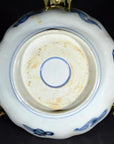Close-up of antique hand painted Japanese Imari porcelain bowl on gold-colored metal stand.