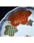 Close-up of an antique hand painted Japanese Imari porcelain bowl on a plain white background.