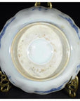 Close-up of the underside of an antique hand painted Japanese Imari porcelain bowl on a brass stand.