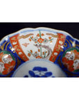 Close-up of a multicolored porcelain Japanese Imari bowl with hand painted floral and geometric patterns.