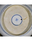 Blue porcelain bowl base close-up with blue square mark within double blue circles.