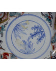 Close-up of blue and multicolor hand painted Japanese Imari porcelain bowl with floral and crane designs.
