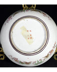 Close-up of the base of an antique hand painted Japanese Kutani porcelain bowl on a metal stand.