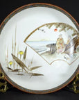 Multicolor porcelain Kutani bowl with hand-painted man by the sea, birds, plants, sun, and geometric border design.