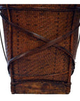 Natural rattan handwoven farmer's basket with crisscrossed wooden supports and sturdy wood base, front view.