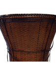 Close-up of natural rattan handwoven farmer's basket with flared rim, white background.