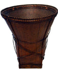 Natural rattan cone-shaped farmer's basket with wide opening and narrow wooden base, close-up.