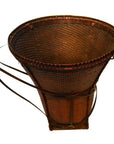 Natural rattan farmer's basket, large conical shape with two sturdy handles and wide top opening, close-up view.