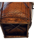 Close-up of brown rattan and wood basket bottom with intricate wicker pattern.