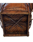Close-up of brown rattan basket base with wooden frame and diagonal supports.