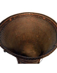 Dark brown handwoven rattan farmer's basket with flared rim, top view.