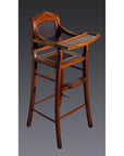 Brown wooden antique highchair with rattan back, tray table, and footrest against a dark background.
