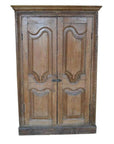 Brown wooden antique Indian cabinet with double carved doors and decorative panels, front view.
