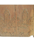 Brown Sheesham wood antique Indian door with carved animal and ornate foliage designs, close-up.