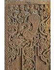 Brown Sheesham wood door with intricate carvings, featuring a stylized bird among floral and swirling patterns.