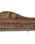 Red, gold, and brown hand carved wood wall ornament with floral and geometric designs, close-up view.