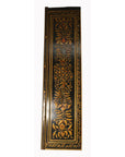 Black and gold lacquered wooden door with 19th-century Indian floral carvings.
