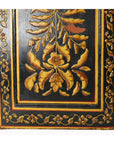 Black lacquered wooden door with gold and yellow floral motifs and a floral border.