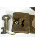 Close-up of rusted metal antique Indian locks with original key on a white surface.