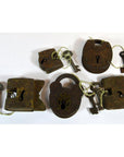 Close-up of five antique brass Indian locks with original keys displayed on a white background.