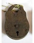 Close-up of antique metal Indian locks with keyhole and string around shackle on white background.