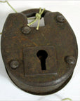 Close-up of rustic metal antique Indian lock with keyhole and string looped through the top shackle.