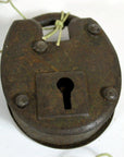 Close-up of rustic metal antique Indian lock with keyhole and string looped through the top shackle.