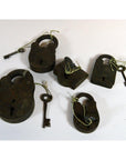 Antique brass Indian locks with matching keys, tied with string, displayed on a white surface.